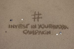 #InvestinYouthWork campaign written in sand