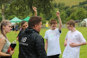 Youth worker talking to young people at an outdoor event