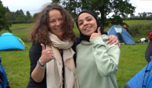 Youth worker and young person give the thumbs up