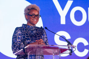 Close upof Gemma Cairney smiling, standing at the podium at the National Youth Work Awards 2023.