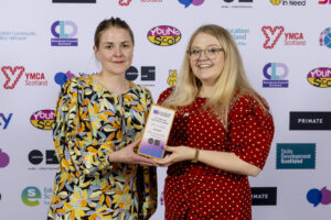 Anna and Holly from Lyra Arts show off their Arts & Creativity trophy at the national youth work awards.