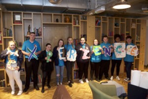 Pciture of a group of young people, each holding a letter which spells out 'Experience'.