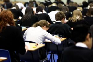 Pupils sitting exams in an exam hall.