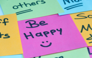 Coloured post-it notes with the words Be Happy and a smily face