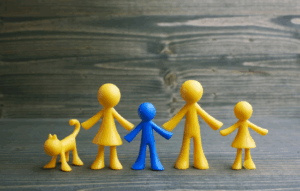 Yellow figures depicting a family with a figure in blue