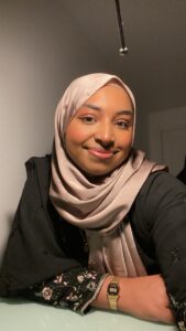 Profile shot of Razannah Hussain wearing a silk headscarf.