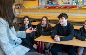 Group of young people in classroom with career adviser