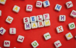 Tiles spelling out the word self harm