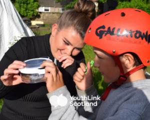 Youth worker and young person learning outside