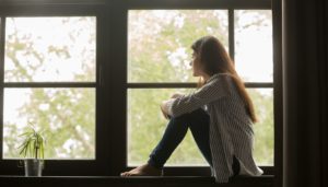 A young person looks out of the window.