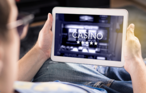 Man holding an ipad with the words casino displayed