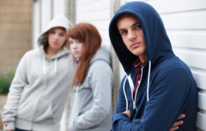Two young women and young man with hoodies