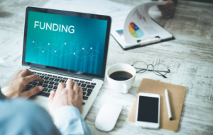 Lap top screen with the word funding