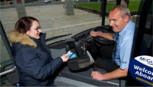 Young woman paying for a bus ticket