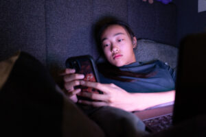 Young-person-looking-at-social-media-credit-NSPCC